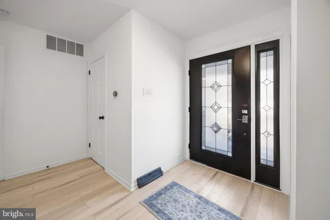 a view of an empty room with closet and windows