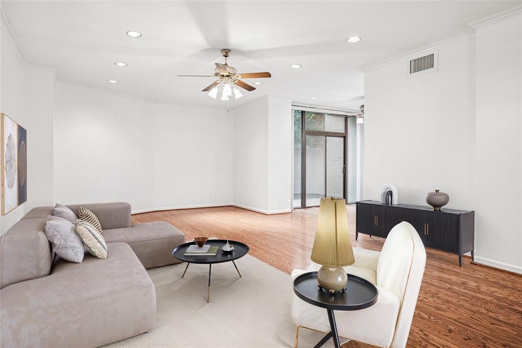 5200 Keller Springs Road, Unit 110 Dallas, TX 75248 - Photo 1 of 28 a living room with furniture and a chandelier
