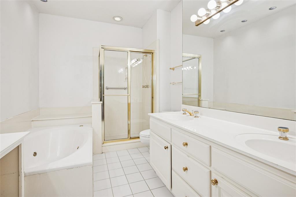 5200 Keller Springs Road, Unit 110 Dallas, TX 75248 - Photo 13 of 28 a spacious bathroom with a shower sink and mirror