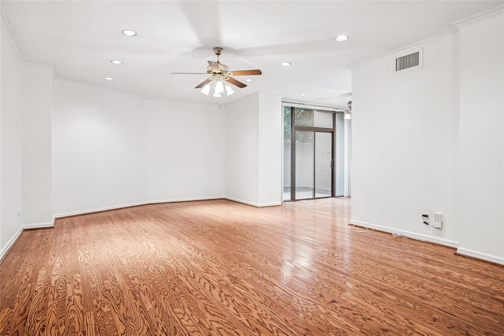 5200 Keller Springs Road, Unit 110 Dallas, TX 75248 - Photo 2 of 28 an empty room with wooden floor and windows