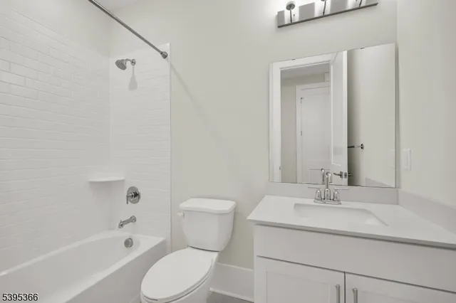 a bathroom with a sink toilet vanity and shower