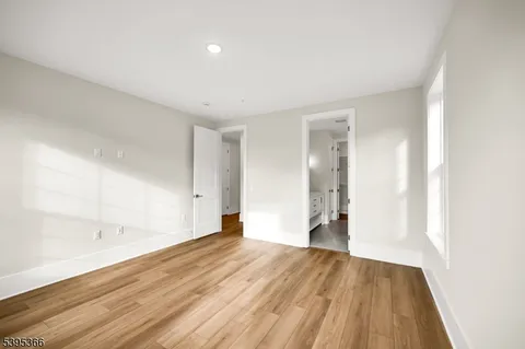a view of an empty room and wooden floor