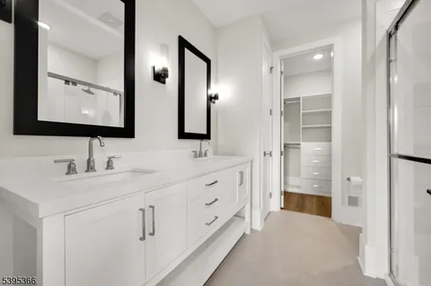 a bathroom with double sink and three mirror