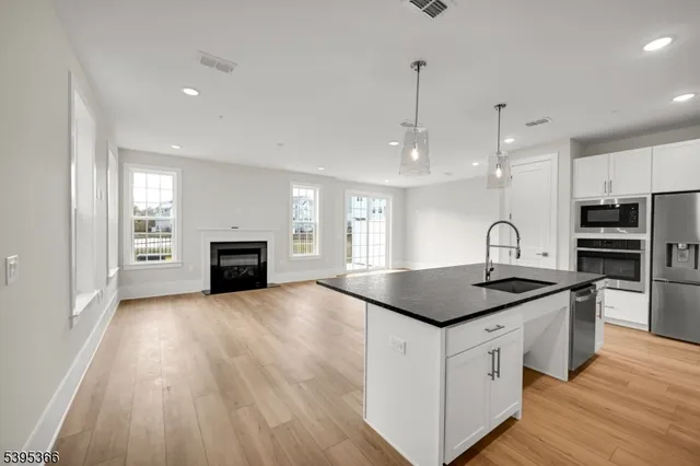 a kitchen with stainless steel appliances granite countertop a sink and stove