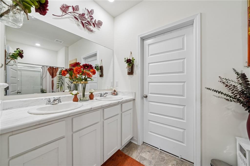 8592 Seabiscuit Road Lithonia, GA 30058 - Photo 11 of 25 a bathroom with a sink and a mirror