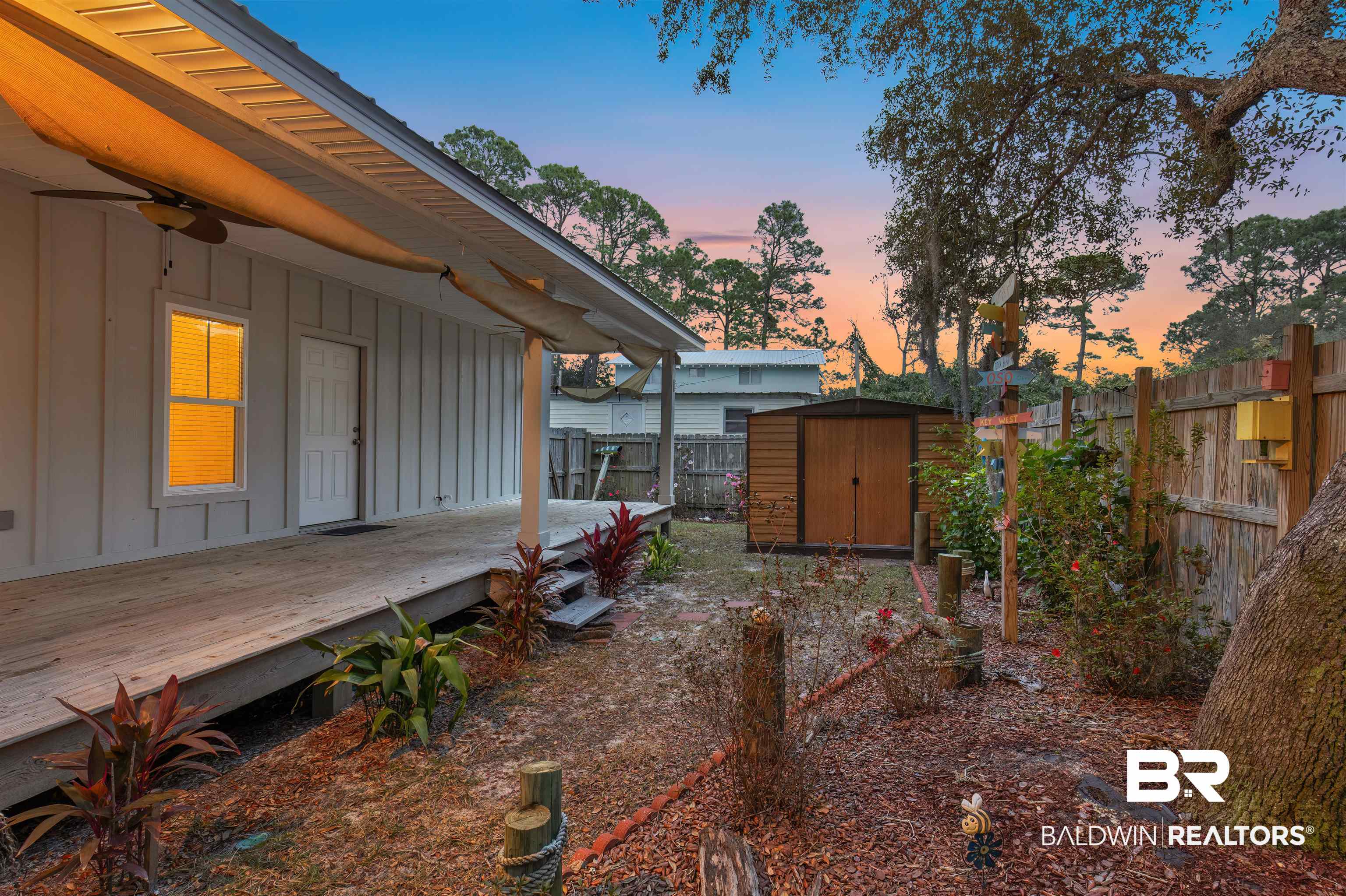 5625 Georgia Street Orange Beach, AL 36561 - Photo 26 of 30 Yard at dusk with a deck and a storage unit