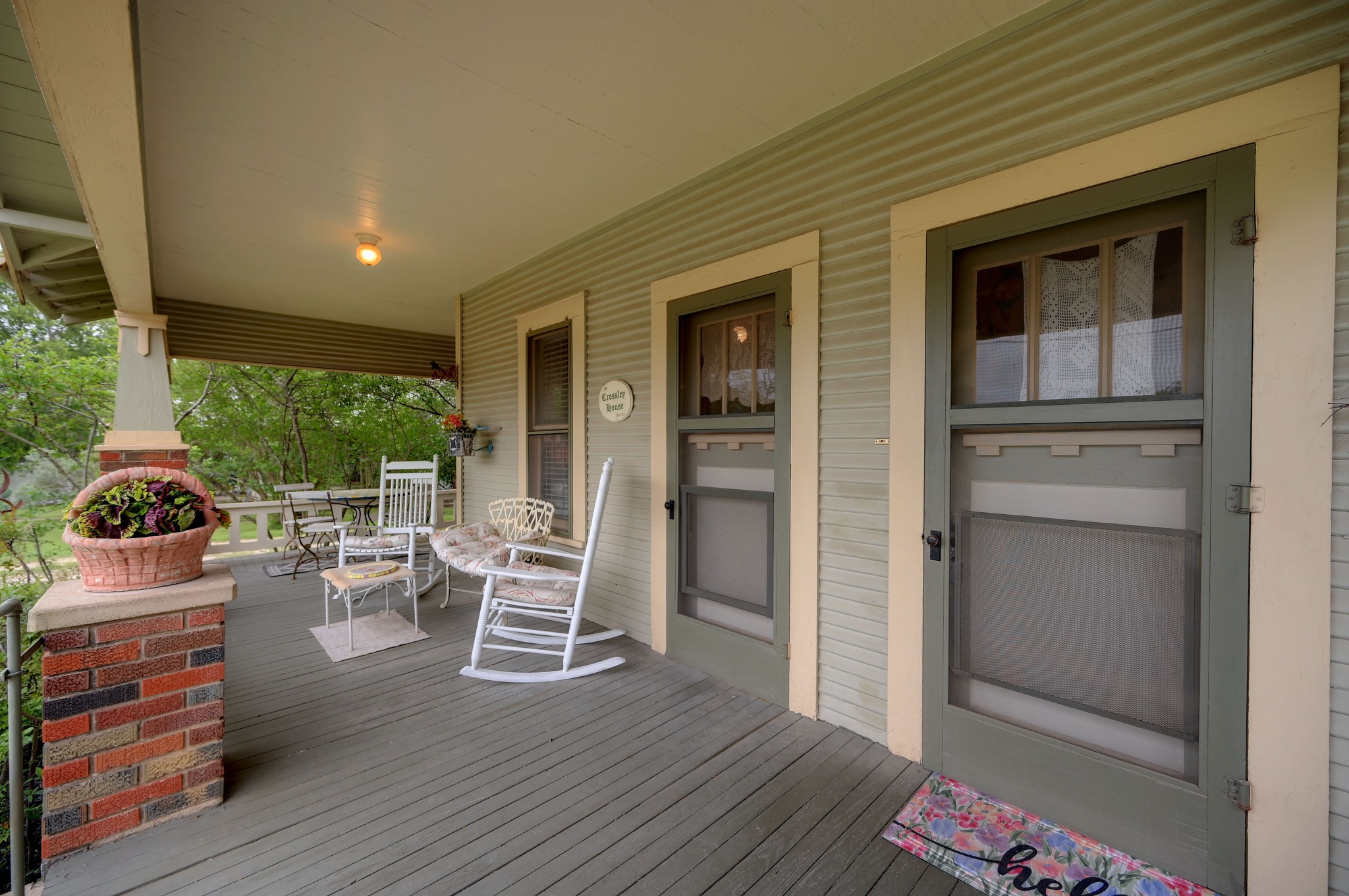 719 Elm Street Blanco, TX 78606 - Photo 4 of 25 Inviting covered porch with painted wood flooring and a brick column accent