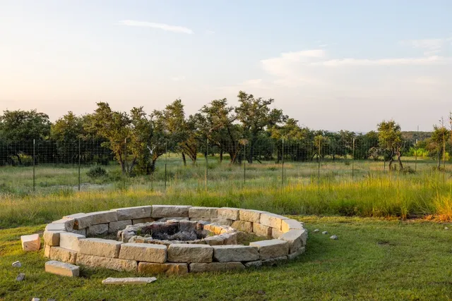 a lake view with a big yard and large trees