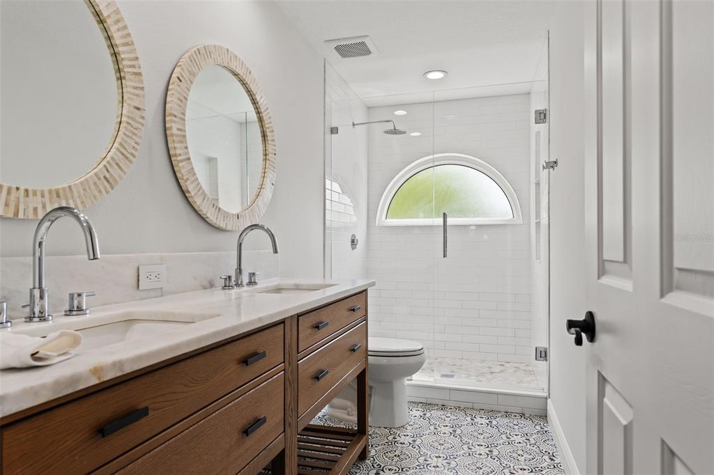11627 Renaissance View Court Tampa, FL 33626 - Photo 23 of 62 a bathroom with a granite countertop toilet a sink and a mirror