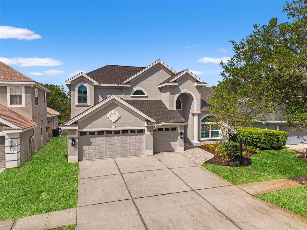 11627 Renaissance View Court Tampa, FL 33626 - Photo 33 of 62 a front view of a house with a garden