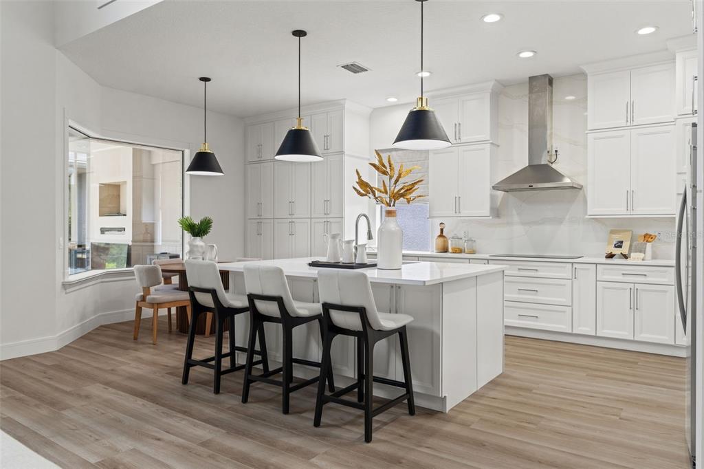 11627 Renaissance View Court Tampa, FL 33626 - Photo 37 of 62 a kitchen with stainless steel appliances granite countertop wooden floor window and chairs