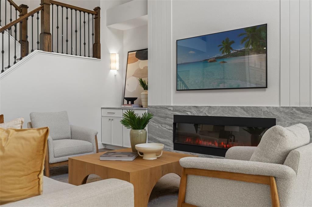 11627 Renaissance View Court Tampa, FL 33626 - Photo 45 of 62 a living room with furniture a fireplace and a potted plant