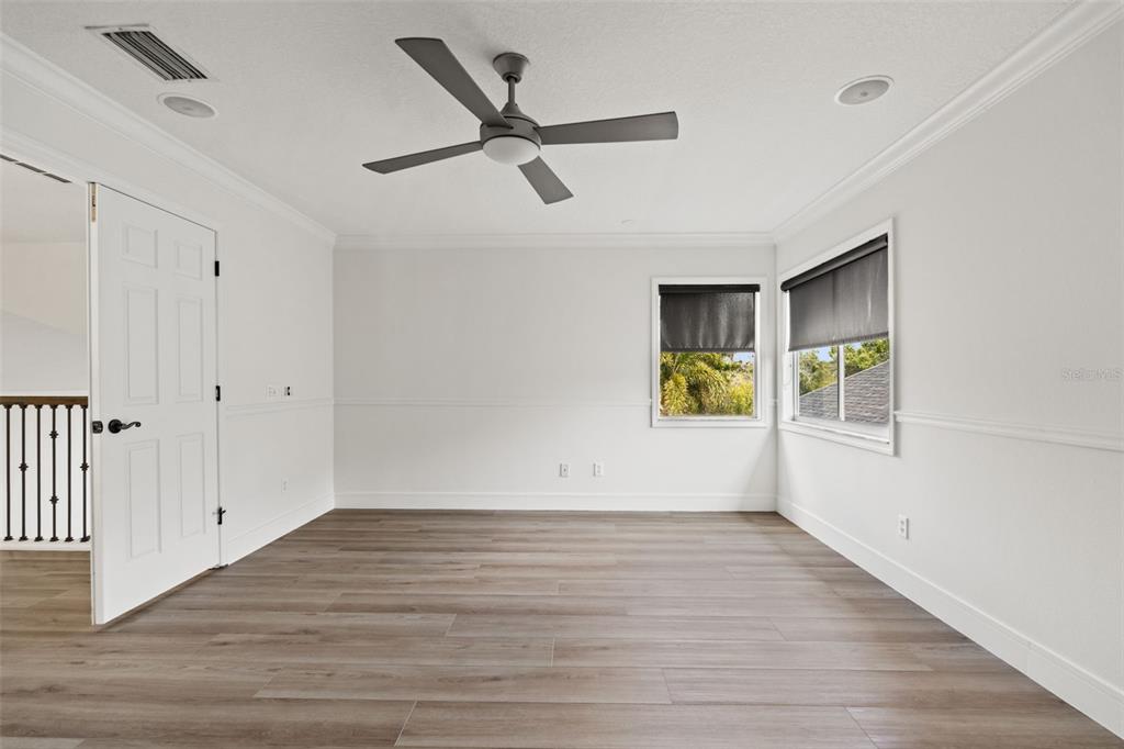 11627 Renaissance View Court Tampa, FL 33626 - Photo 57 of 62 an empty room with wooden floor and windows