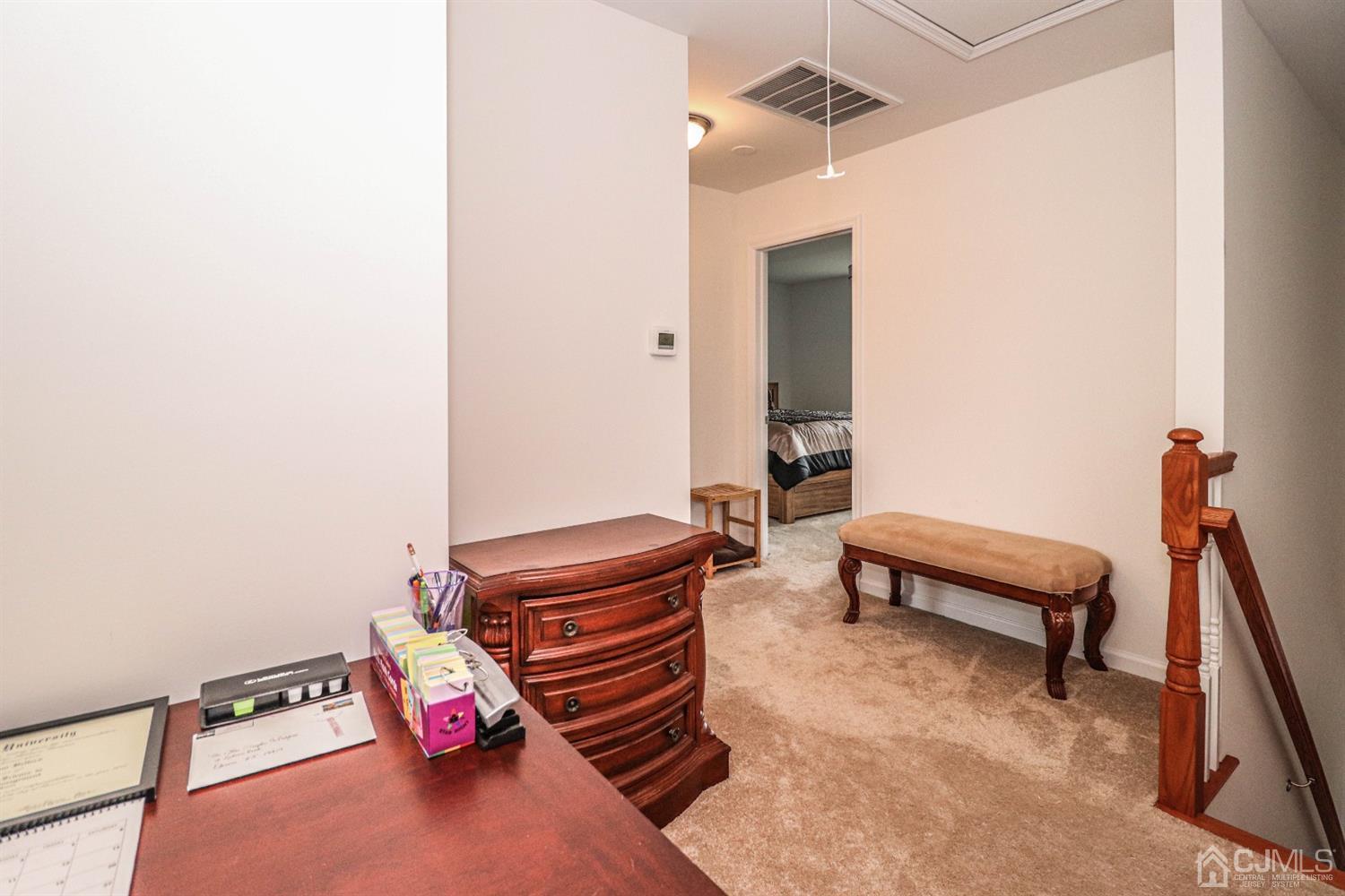 10 Matson Road Edison, NJ 08817 - Photo 23 of 40 a room with a bed and a chandelier
