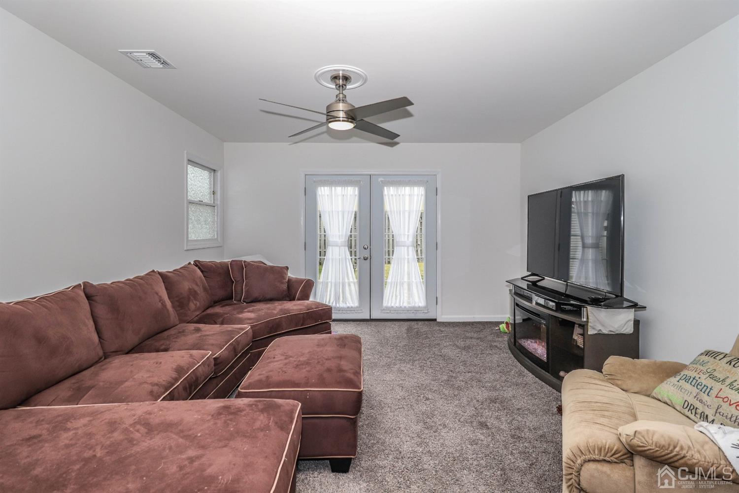 10 Matson Road Edison, NJ 08817 - Photo 9 of 40 a living room with furniture a ceiling fan and a window