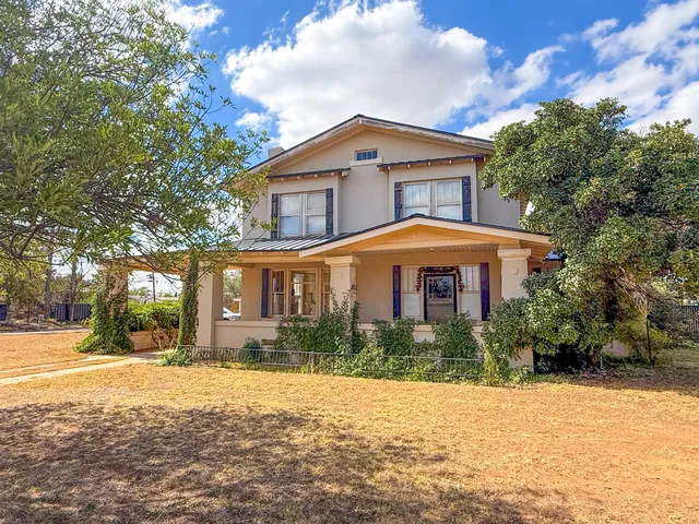 a backyard of a house with plants and trees