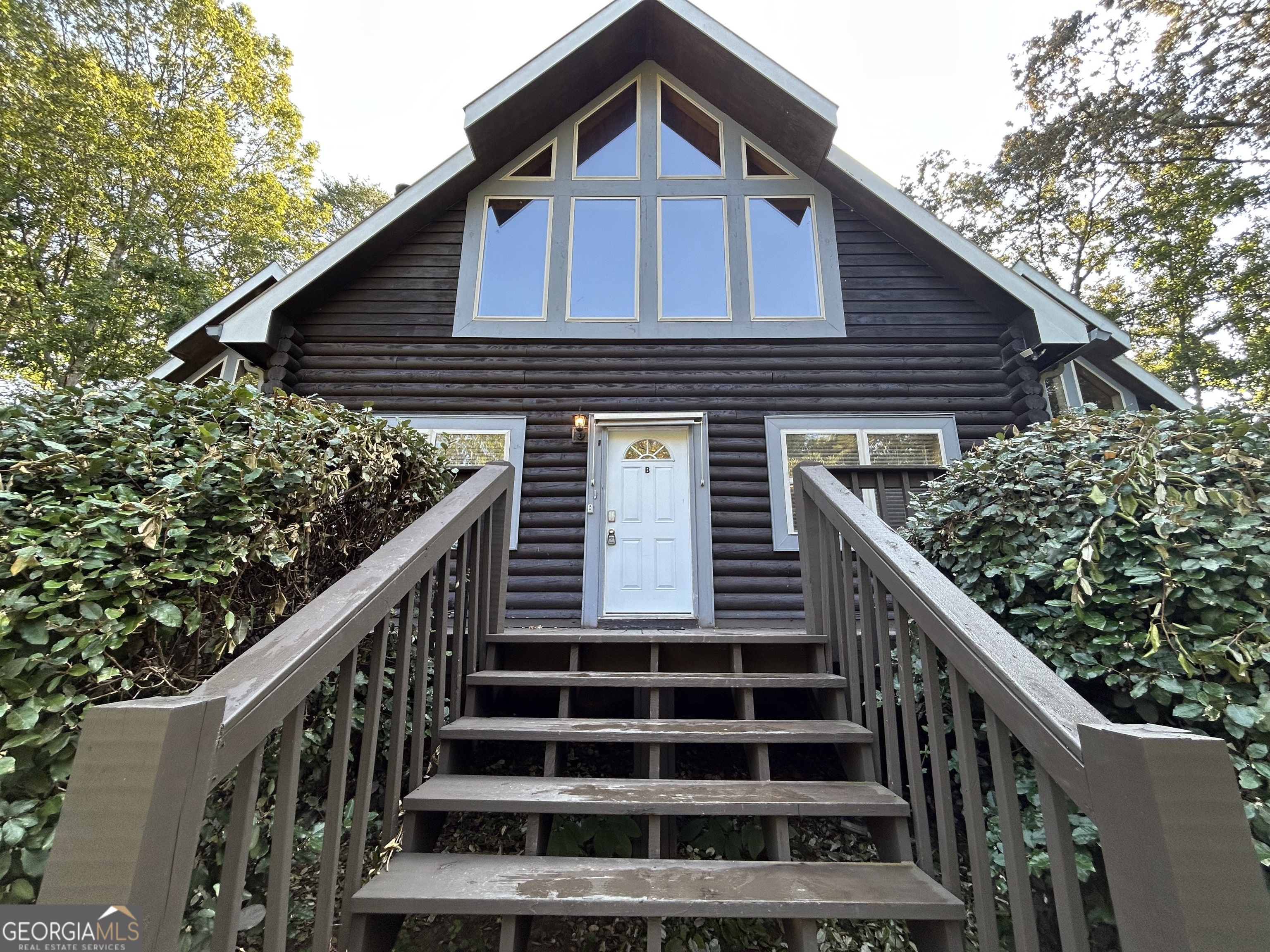 a view of a house with wooden fence and windows