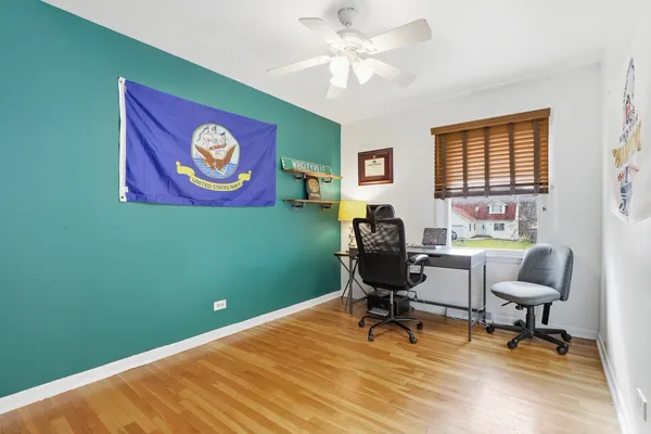 a view of a livingroom with workspace and a window