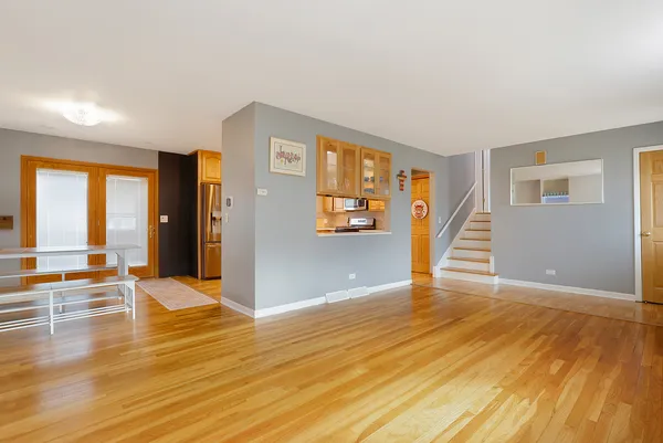 a view of a livingroom with wooden floor and stairs