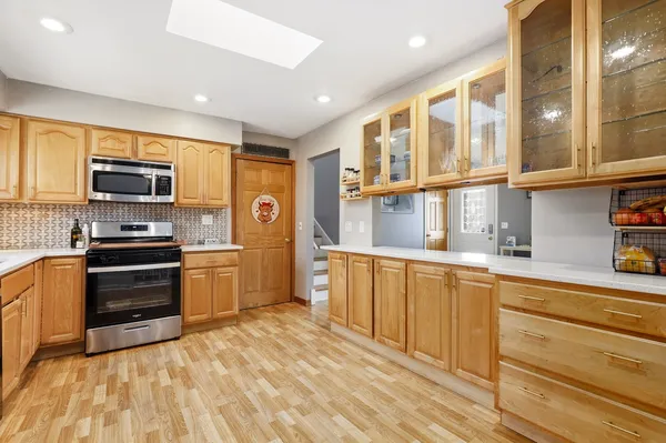 a kitchen with stainless steel appliances granite countertop a refrigerator and a stove top oven