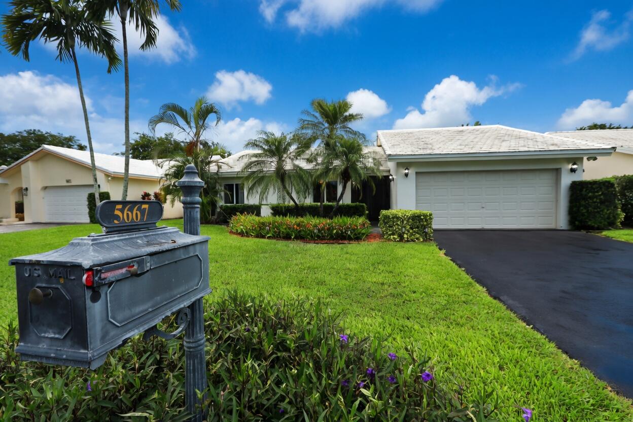 5667 North Cameo Drive Boca Raton, FL 33433 - Photo 1 of 20 a view of a house with a back yard