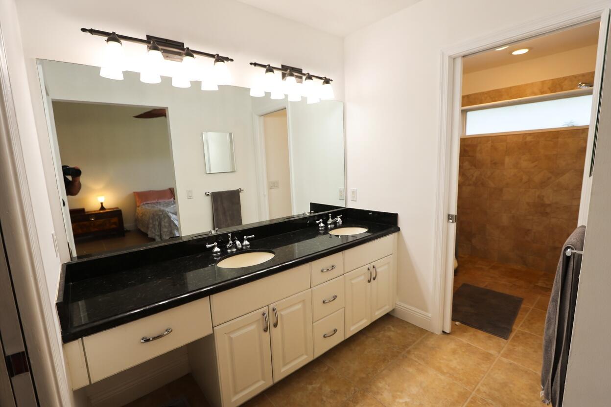 5667 North Cameo Drive Boca Raton, FL 33433 - Photo 12 of 20 a spacious bathroom with a double vanity sink and a mirror
