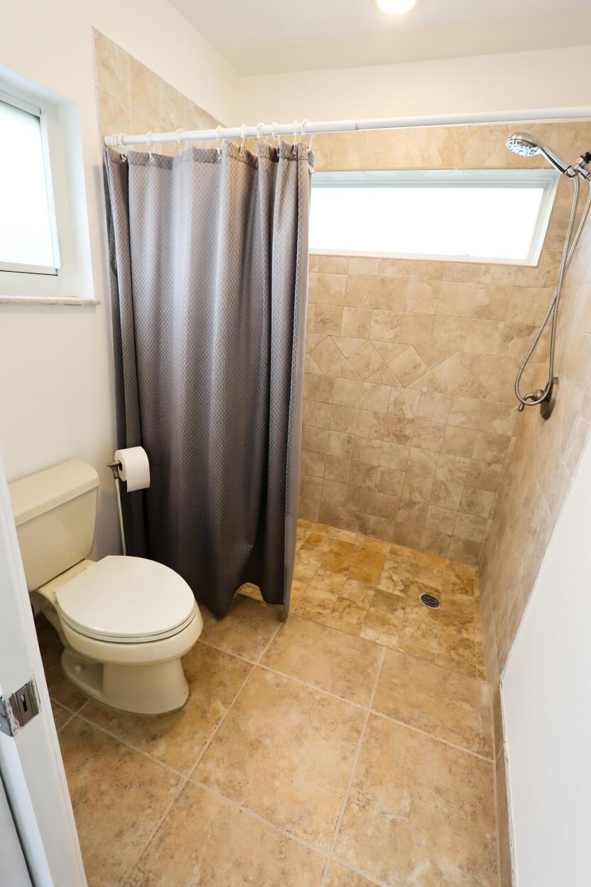 5667 North Cameo Drive Boca Raton, FL 33433 - Photo 13 of 20 a bathroom with a toilet and a shower
