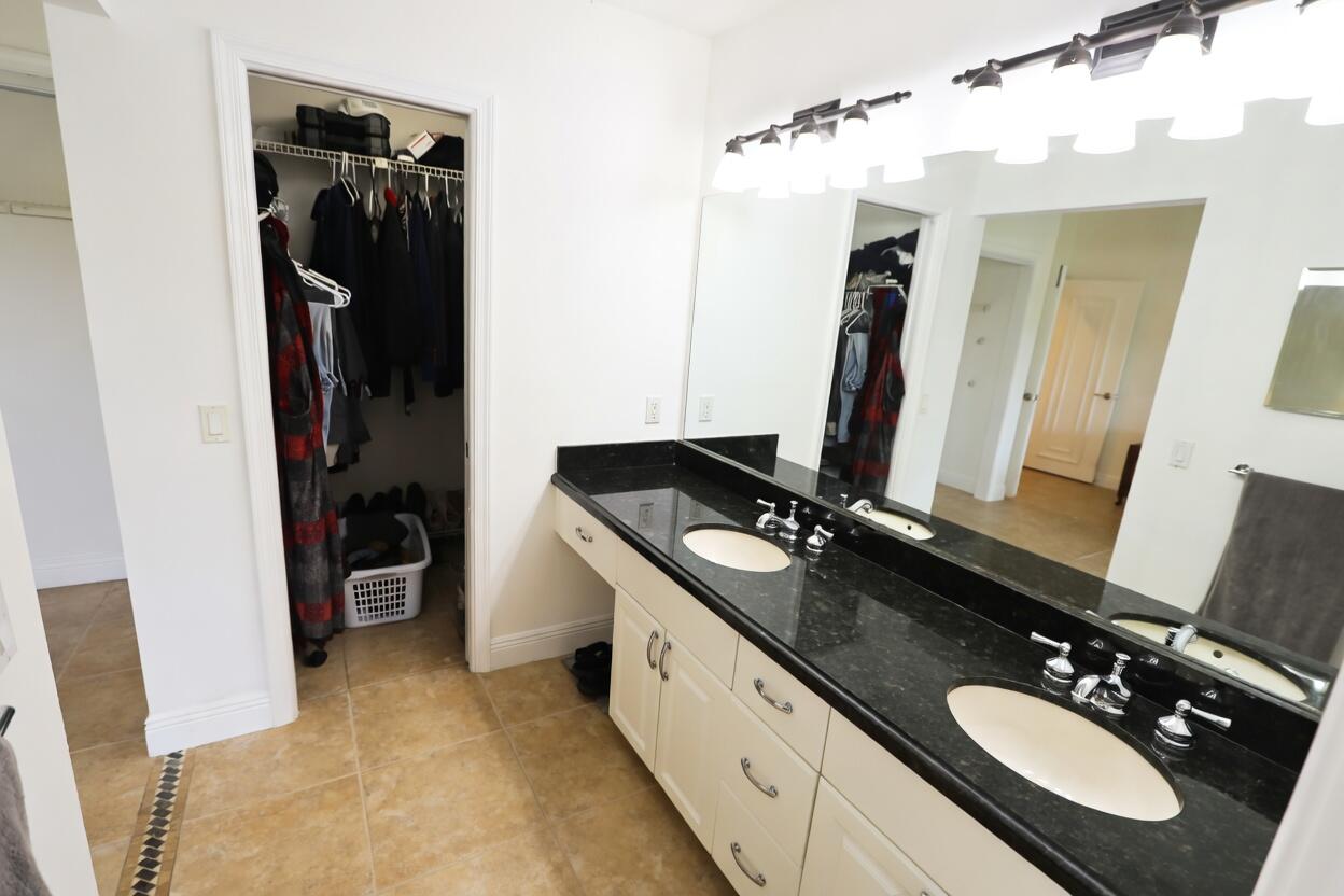 5667 North Cameo Drive Boca Raton, FL 33433 - Photo 14 of 20 a bathroom with a double vanity sink and mirror