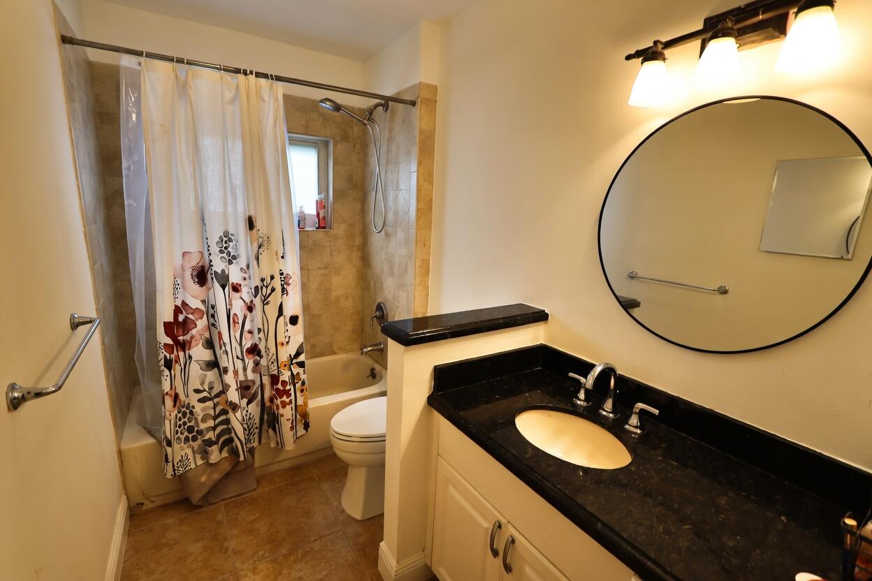 5667 North Cameo Drive Boca Raton, FL 33433 - Photo 16 of 20 a bathroom with a sink and a mirror