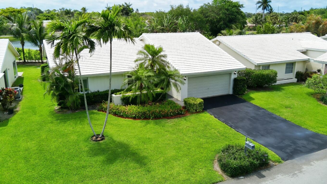 5667 North Cameo Drive Boca Raton, FL 33433 - Photo 18 of 20 a view of a backyard with a garden