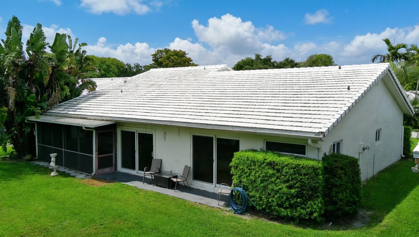 5667 North Cameo Drive Boca Raton, FL 33433 - Photo 19 of 20 a view of a house with backyard and a garden