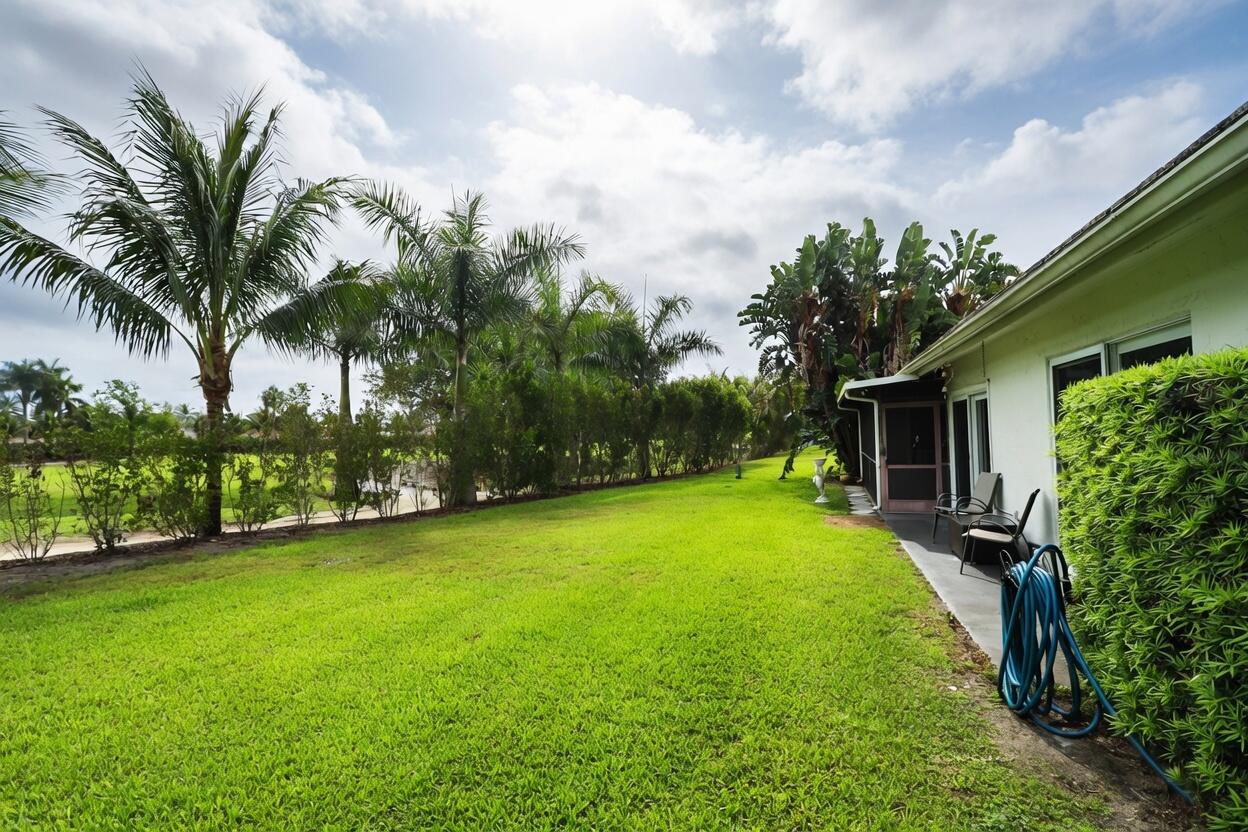 5667 North Cameo Drive Boca Raton, FL 33433 - Photo 20 of 20 a backyard of a house with table and chairs