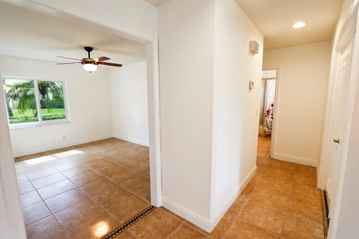 5667 North Cameo Drive Boca Raton, FL 33433 - Photo 9 of 20 wooden floor in an empty room with a window
