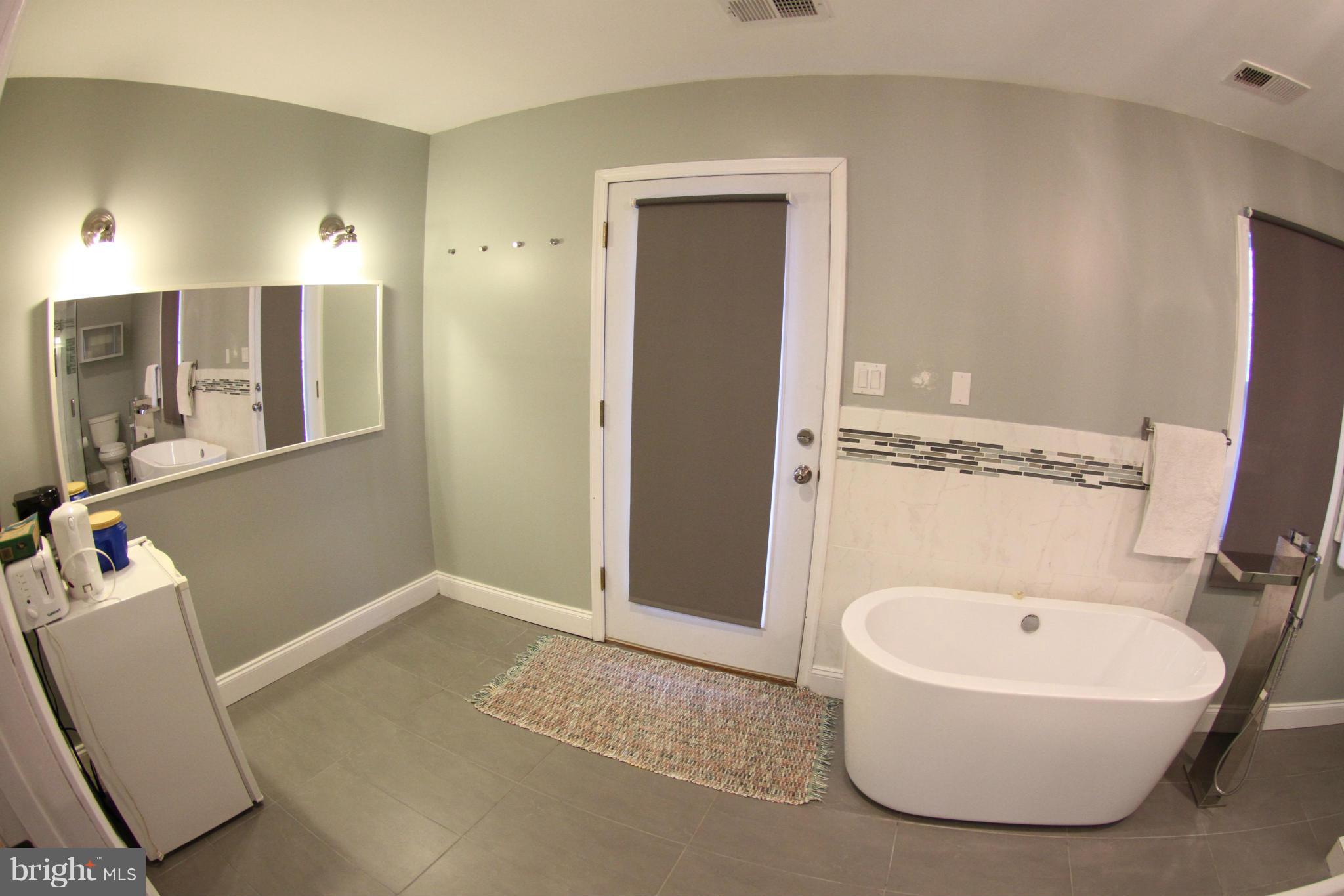 1542 Crowell Road Vienna, VA 22182 - Photo 11 of 55 a bathroom with a tub a toilet and a sink