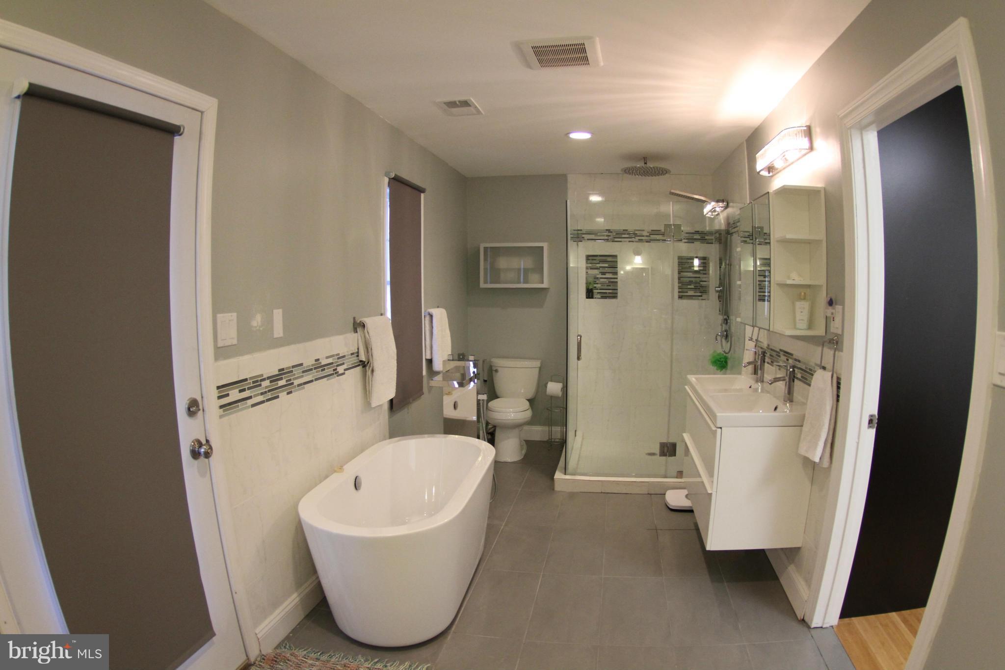 1542 Crowell Road Vienna, VA 22182 - Photo 12 of 55 a bathroom with a sink a toilet and shower