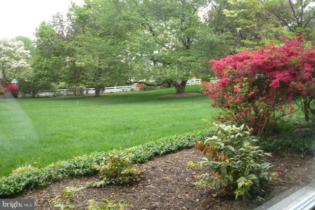 a view of a bathroom with a tub and mirror