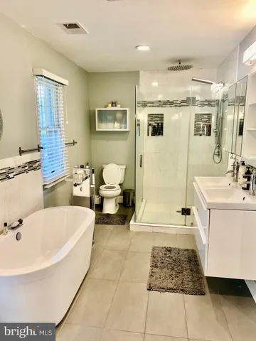 a bathroom with a sink a mirror and a bathtub