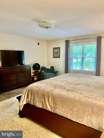 a bedroom with a bed and dresser