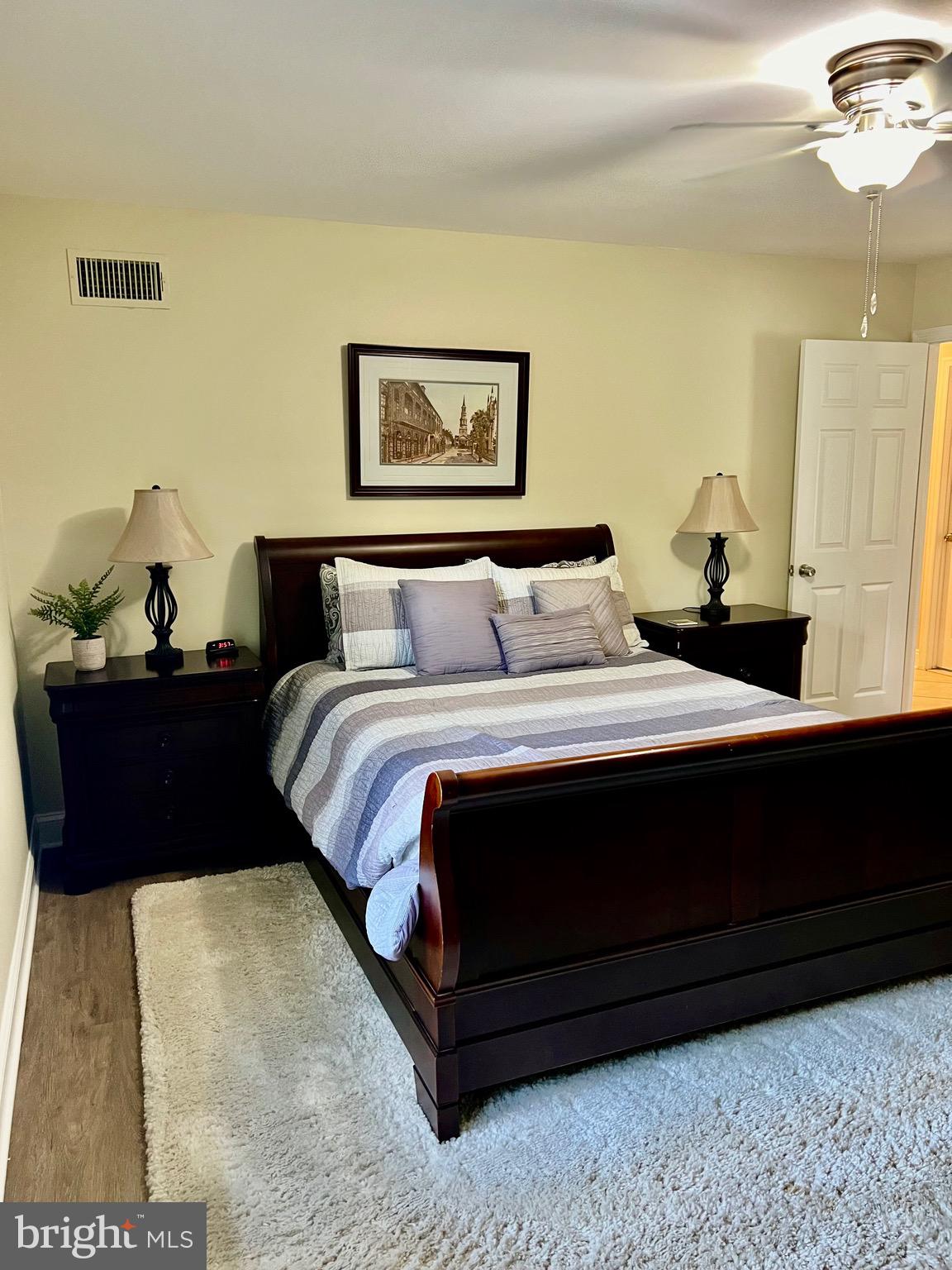 1542 Crowell Road Vienna, VA 22182 - Photo 37 of 55 a bedroom with a bed and a painting on the wall