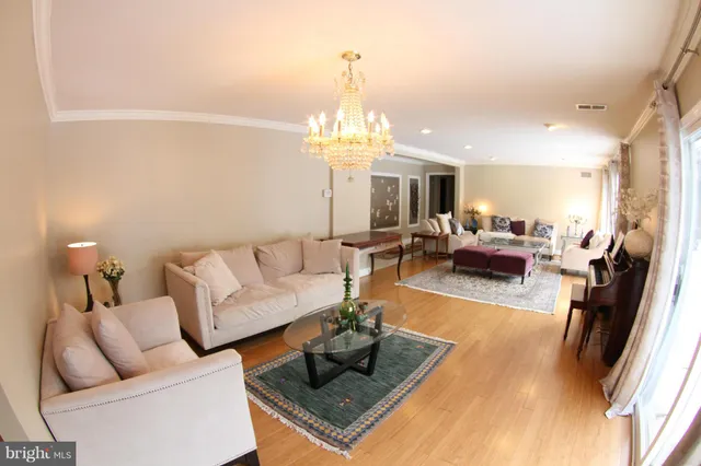 a living room with furniture and a chandelier