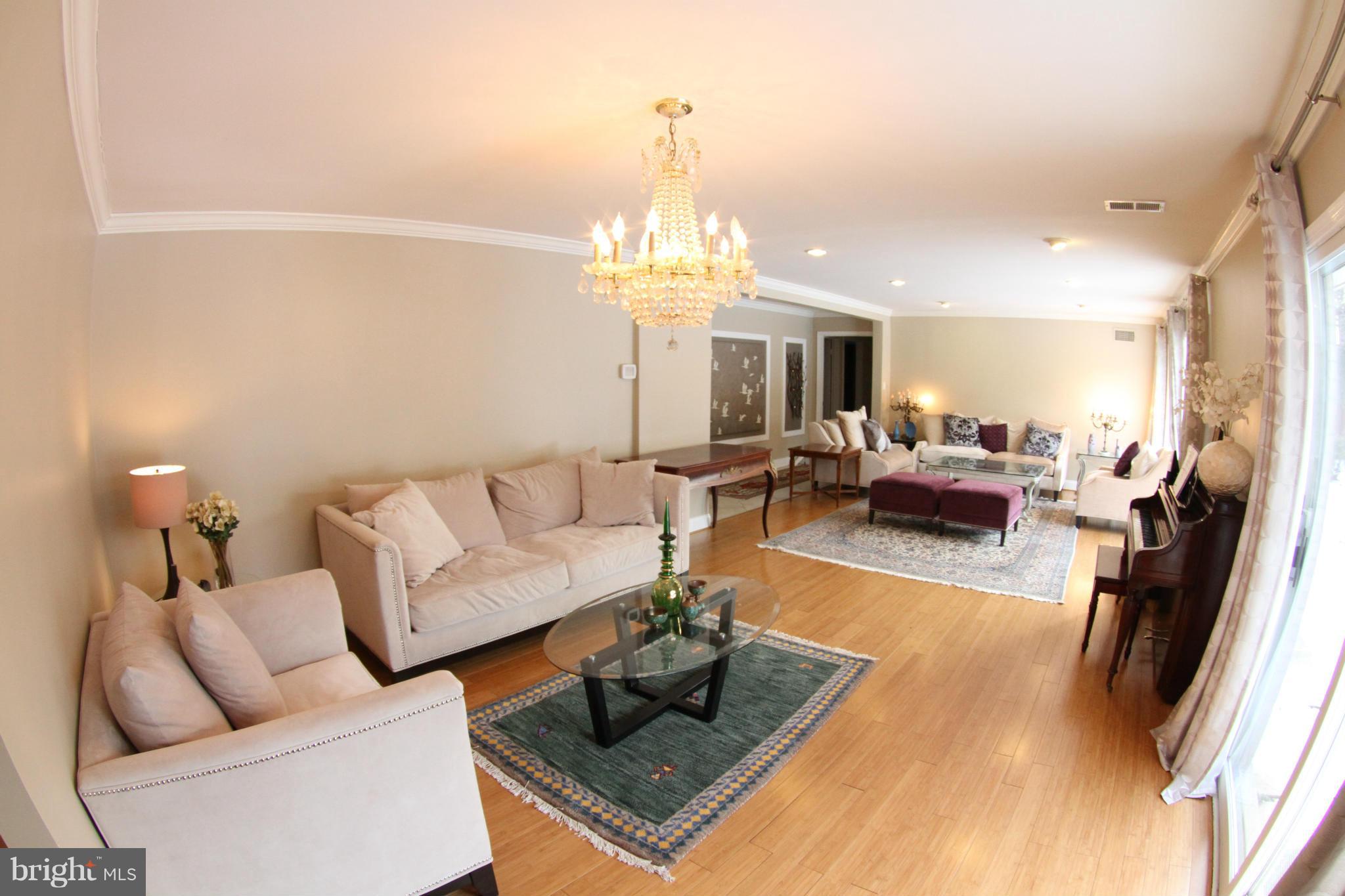 1542 Crowell Road Vienna, VA 22182 - Photo 4 of 55 a living room with furniture and a chandelier