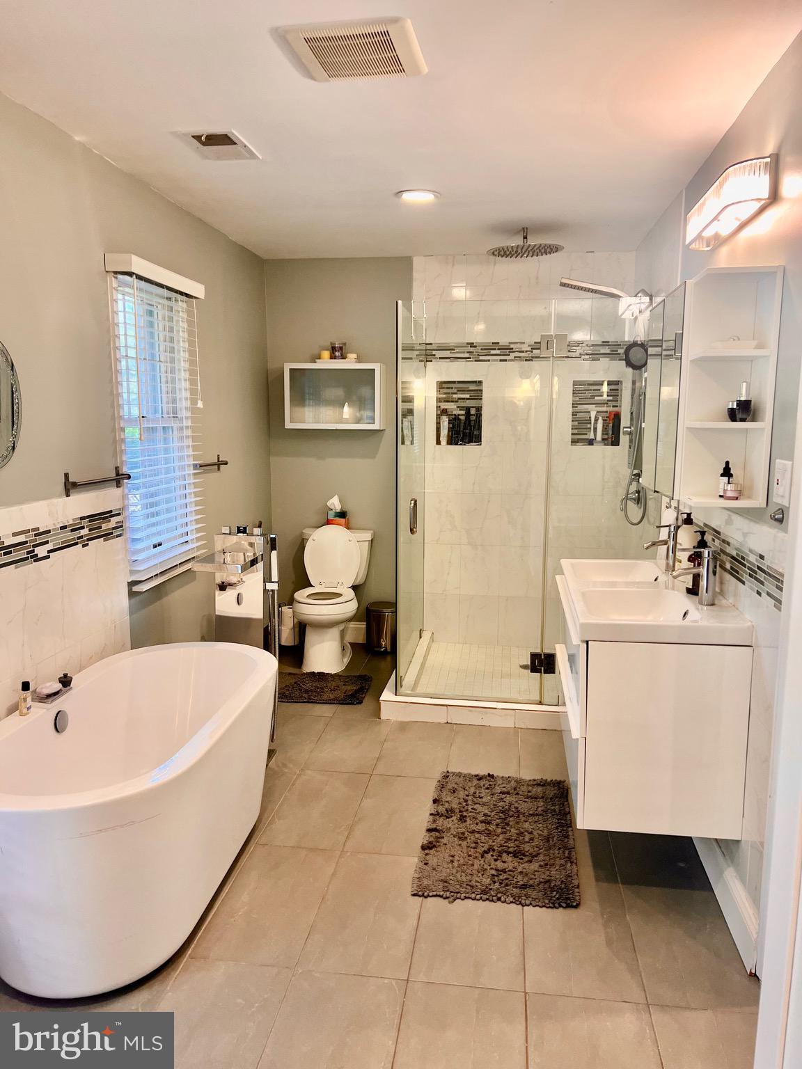 1542 Crowell Road Vienna, VA 22182 - Photo 46 of 55 a bathroom with a tub sink and mirror