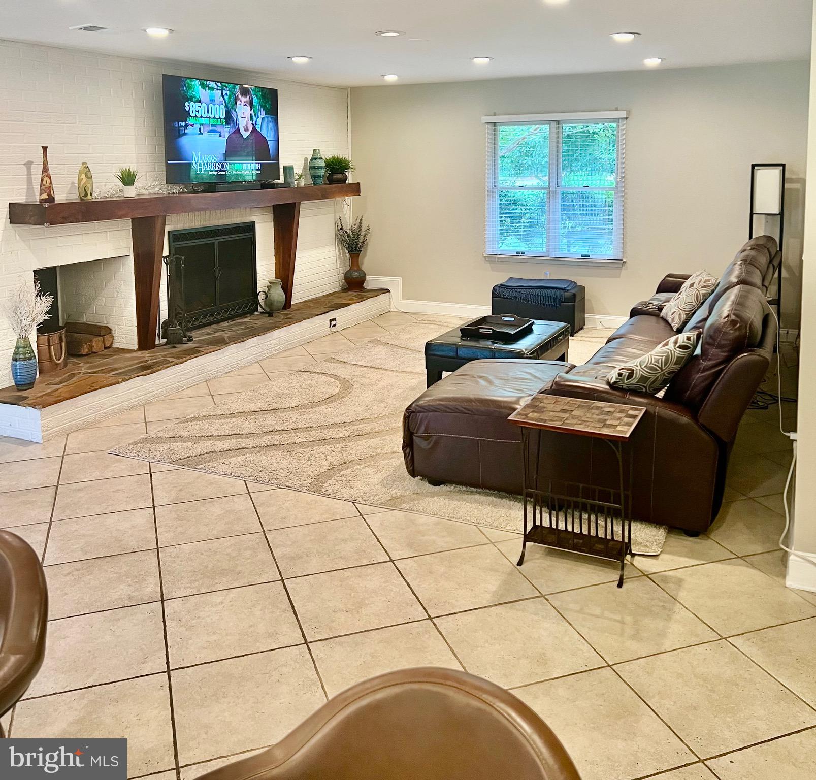 1542 Crowell Road Vienna, VA 22182 - Photo 48 of 55 a room with furniture and a fireplace