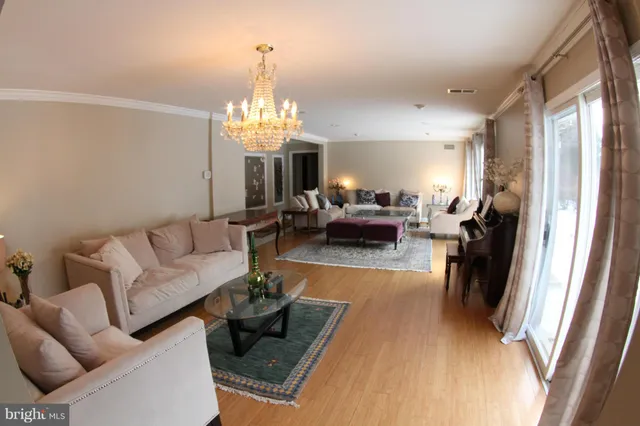 a living room with furniture and a chandelier