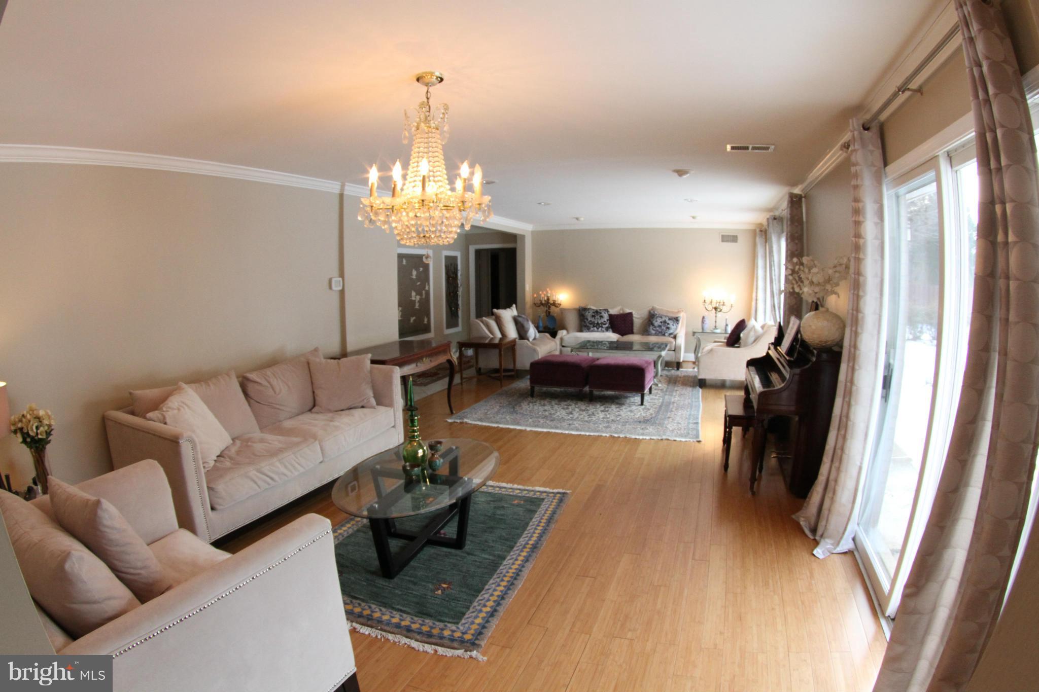 1542 Crowell Road Vienna, VA 22182 - Photo 6 of 55 a living room with furniture and a chandelier