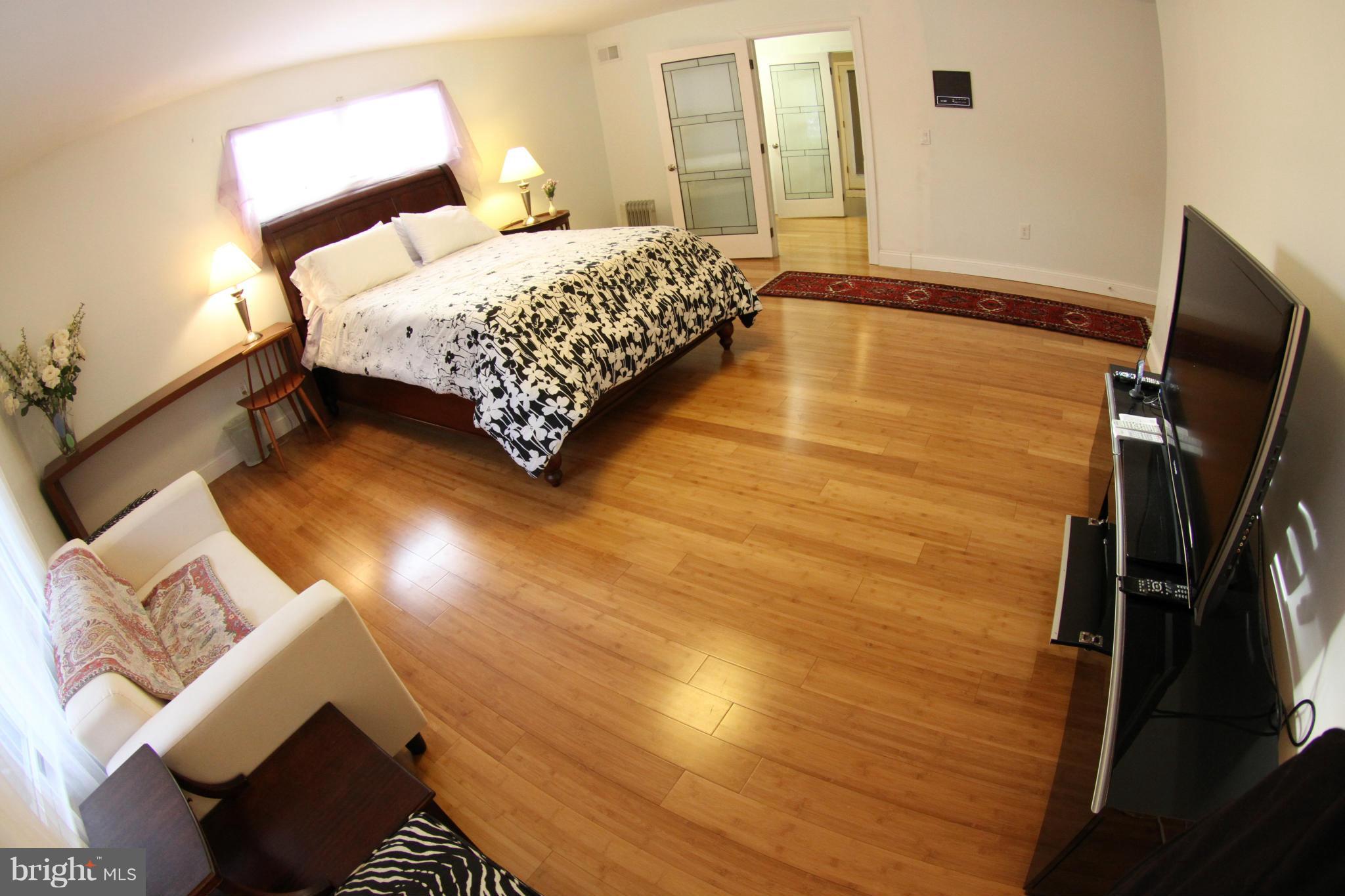 1542 Crowell Road Vienna, VA 22182 - Photo 8 of 55 a bedroom with a bed and wooden floor