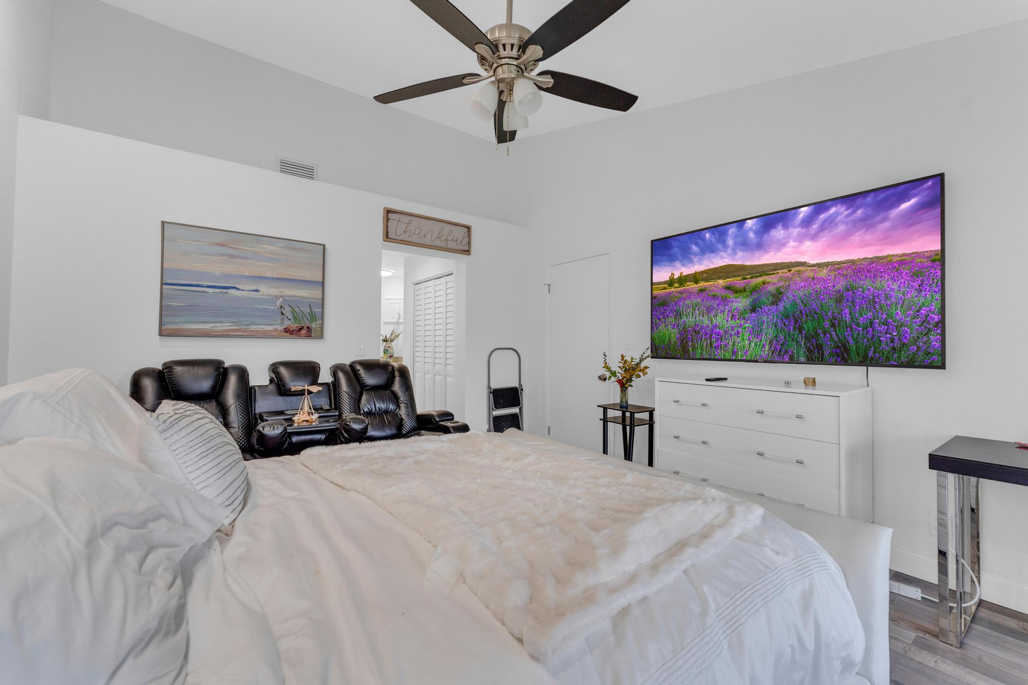 11120 Sangria Court Boca Raton, FL 33498 - Photo 12 of 34 a large bedroom with a bed and a flat screen tv