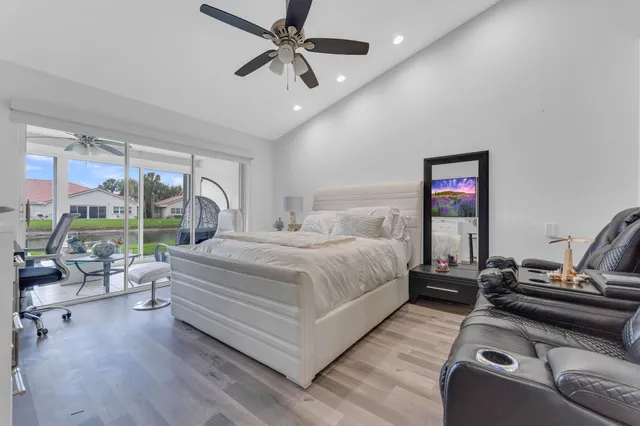 a bedroom with a bed gym equipment and a large window