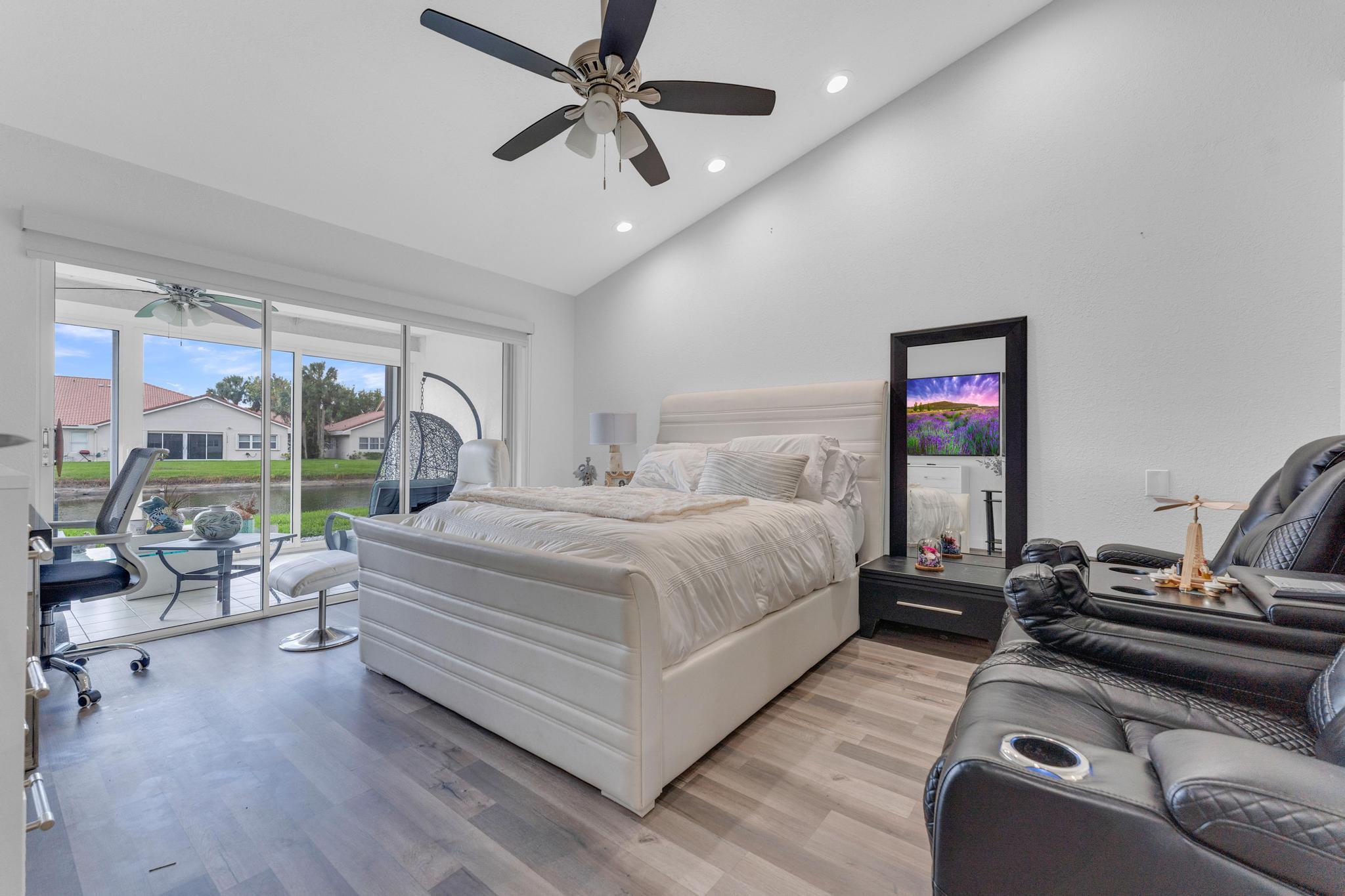 11120 Sangria Court Boca Raton, FL 33498 - Photo 13 of 34 a bedroom with a bed gym equipment and a large window