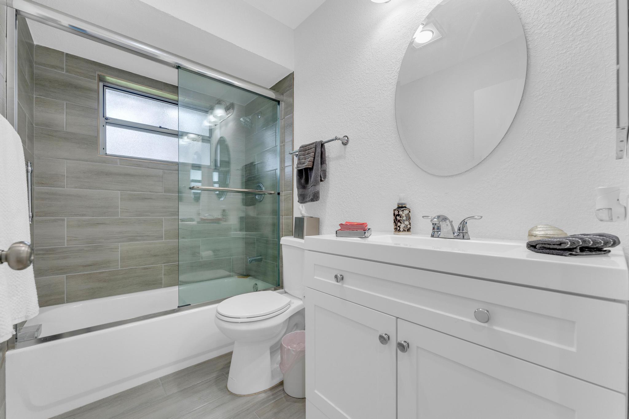 11120 Sangria Court Boca Raton, FL 33498 - Photo 14 of 34 a bathroom with a sink a toilet and a mirror